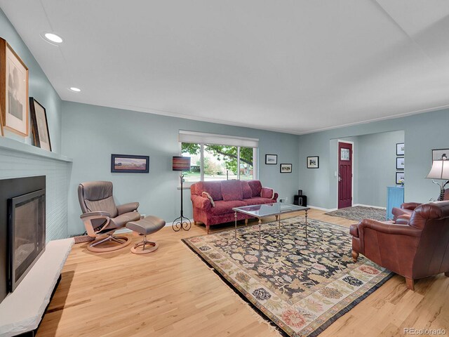 595 W Lake Ave, Littleton, CO 80120 - living area with wood finished floors, a glass covered fireplace, recessed lighting, and baseboards