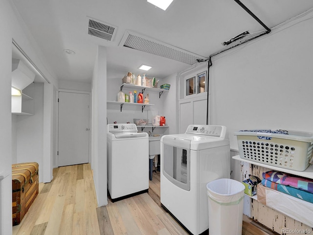 595 W Lake Ave, Littleton, CO 80120 - laundry room featuring washer and clothes dryer and light wood-style flooring