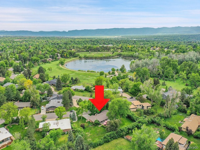 595 W Lake Ave, Littleton, CO 80120 - aerial view of property and surrounding area with a water and mountain view, nearby suburban area, and a heavily wooded area
