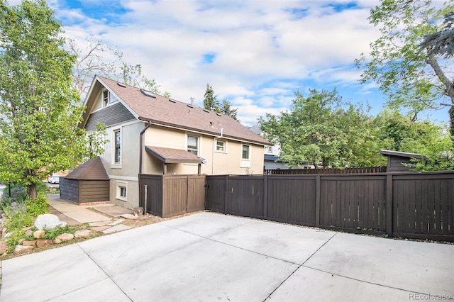 2507 9th St, Boulder, CO 80304 - back of property with stucco siding, a patio area, and a shingled roof