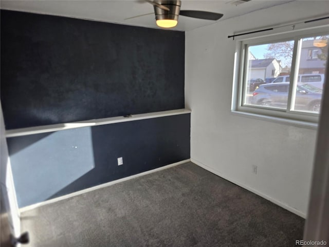 empty room featuring baseboards, carpet floors, and a ceiling fan