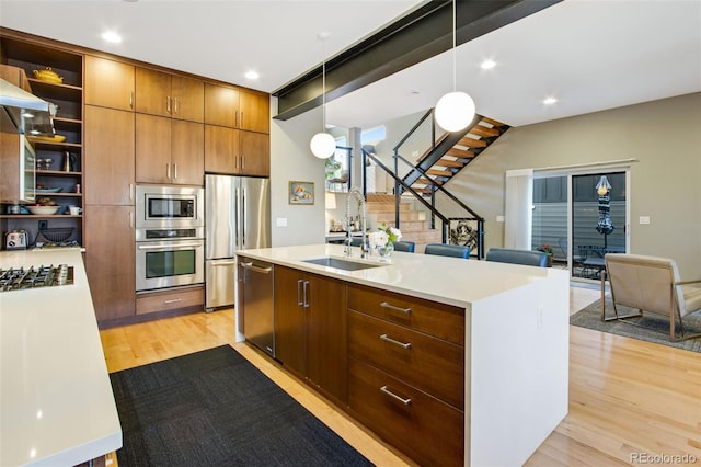 357 Pascal St, Fort Collins, CO 80524 - kitchen with stainless steel appliances, a sink, open shelves, light wood-style floors, and recessed lighting