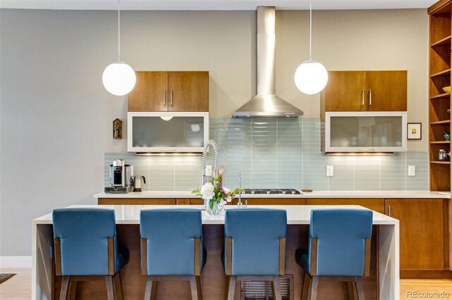 357 Pascal St, Fort Collins, CO 80524 - kitchen with wall chimney exhaust hood, brown cabinets, and pendant lighting