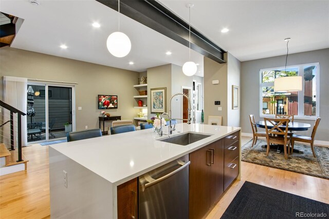357 Pascal St, Fort Collins, CO 80524 - kitchen with stainless steel dishwasher, a sink, light wood finished floors, hanging light fixtures, and recessed lighting