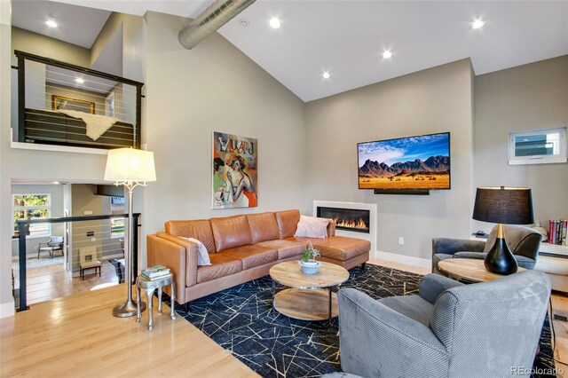 357 Pascal St, Fort Collins, CO 80524 - living room with a glass covered fireplace, high vaulted ceiling, wood finished floors, baseboards, and recessed lighting