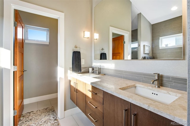 357 Pascal St, Fort Collins, CO 80524 - full bath featuring plenty of natural light, double vanity, decorative backsplash, and tile patterned flooring
