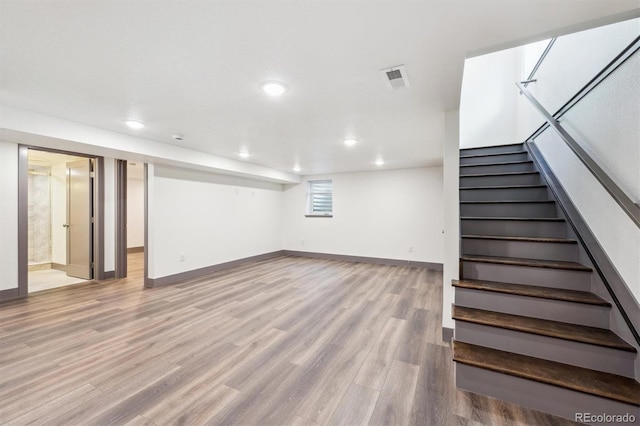 1112-11121/2 Krameria St, Denver, CO 80220 - below grade area featuring stairs, wood finished floors, and recessed lighting