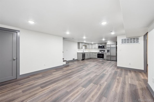 1112-11121/2 Krameria St, Denver, CO 80220 - unfurnished living room with wood finished floors and recessed lighting