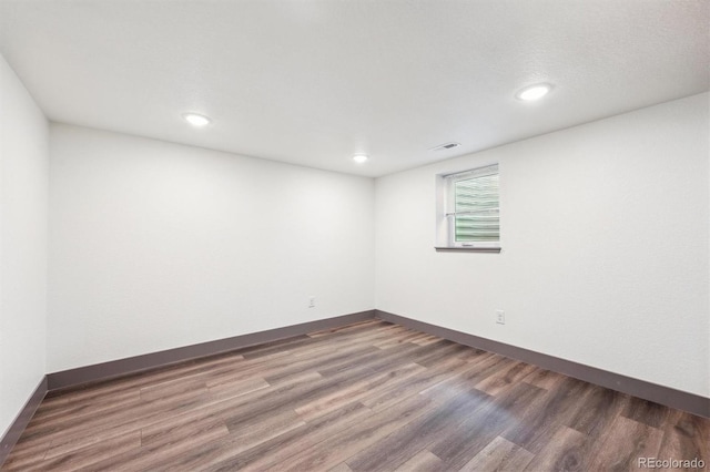 1112-11121/2 Krameria St, Denver, CO 80220 - empty room featuring wood finished floors and recessed lighting