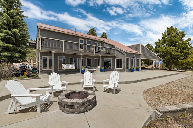 369 County Road 4051, Granby, CO 80446 - rear view of house featuring a fire pit, a patio area, and metal roof