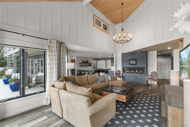 369 County Road 4051, Granby, CO 80446 - living room with wood finished floors, a chandelier, high vaulted ceiling, wooden ceiling, and a glass covered fireplace