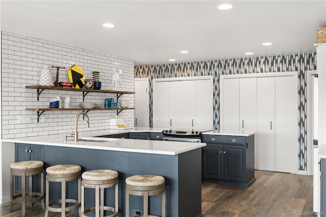 369 County Road 4051, Granby, CO 80446 - kitchen featuring a sink, a peninsula, a kitchen breakfast bar, light countertops, and recessed lighting