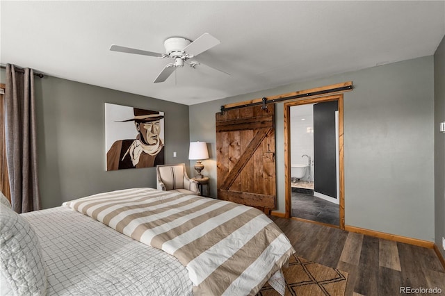 369 County Road 4051, Granby, CO 80446 - bedroom with a barn door, dark wood-type flooring, baseboards, ceiling fan, and connected bathroom