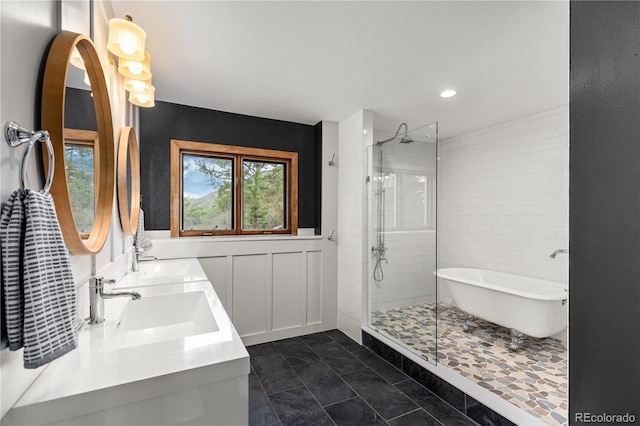 369 County Road 4051, Granby, CO 80446 - bathroom with a shower stall, a freestanding tub, double vanity, wainscoting, and recessed lighting