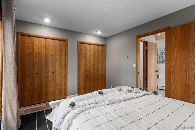369 County Road 4051, Granby, CO 80446 - bedroom featuring two closets, a baseboard heating unit, a textured ceiling, and recessed lighting