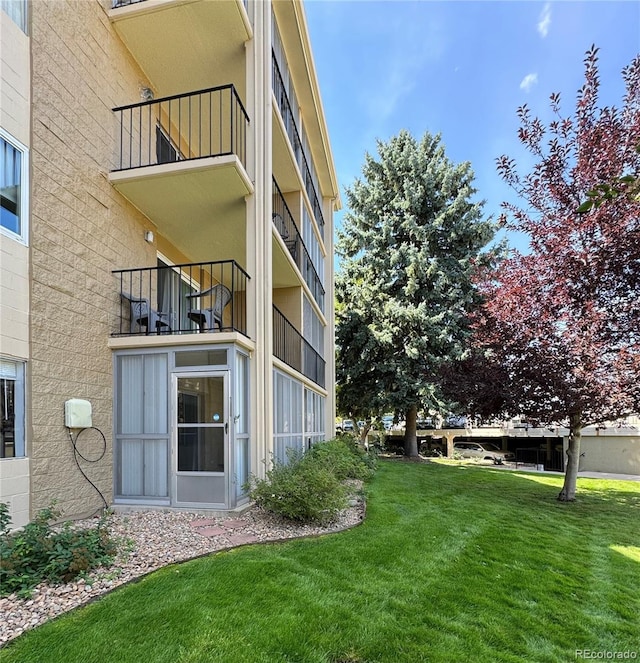 view of yard featuring a balcony