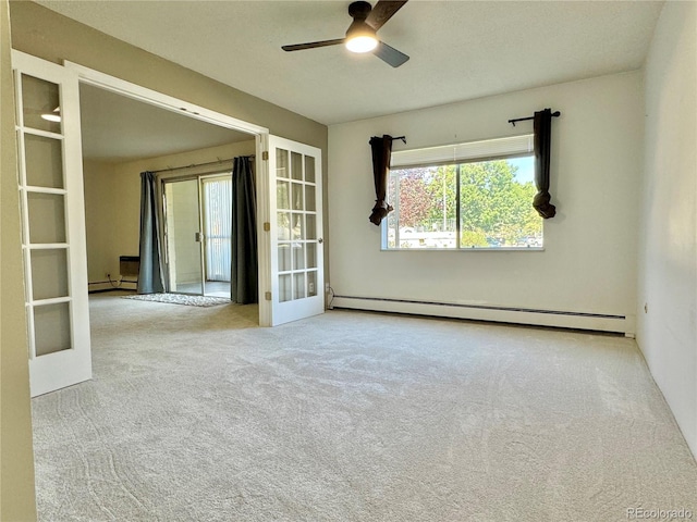 carpeted spare room with ceiling fan, french doors, and baseboard heating