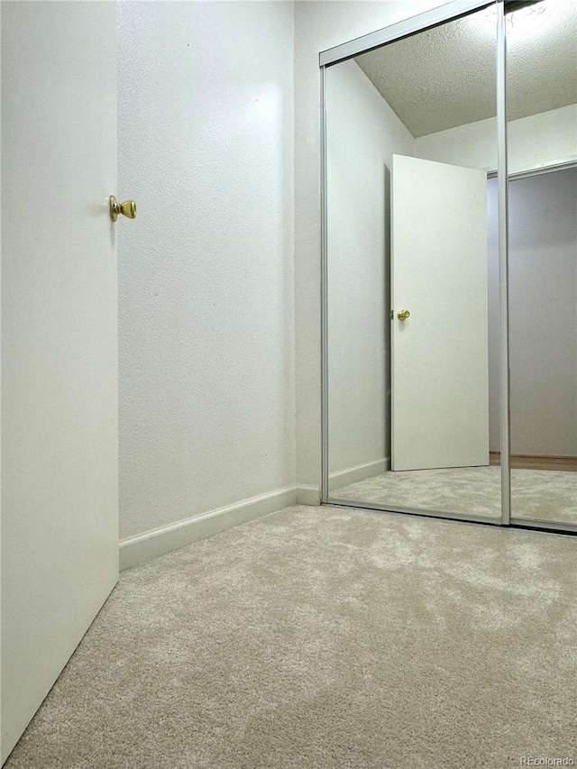 bathroom featuring a textured ceiling and baseboards