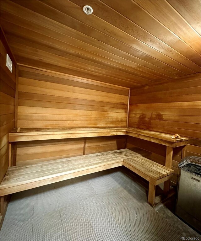 view of sauna featuring wood ceiling and wood walls