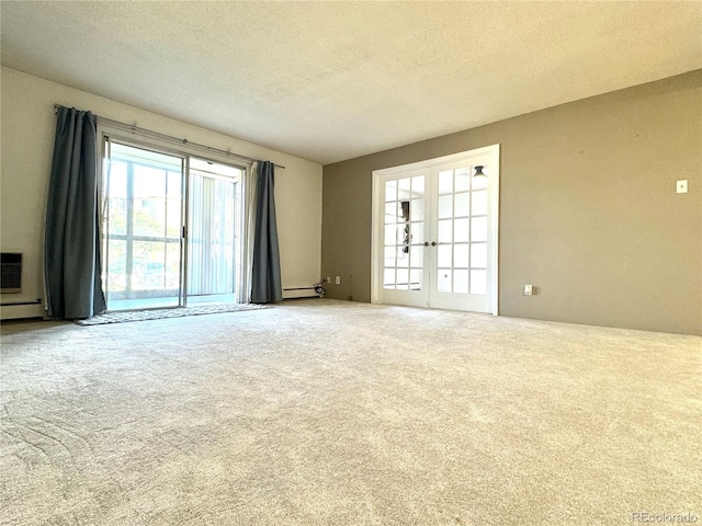 empty room with french doors, a textured ceiling, and carpet floors