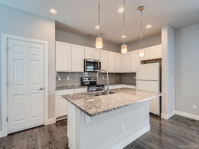 4773 Kittredge St, Denver, CO 80239 - kitchen featuring appliances with stainless steel finishes, a sink, white cabinetry, dark wood-style floors, and backsplash