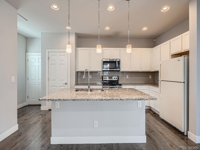 4773 Kittredge St, Denver, CO 80239 - kitchen with appliances with stainless steel finishes, a sink, decorative backsplash, dark wood-style flooring, and recessed lighting