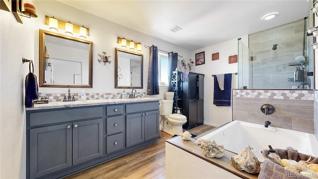 40291 Gold Nugget Dr, Deer Trail, CO 80105 - full bathroom with wood finished floors, double vanity, a garden tub, and a tile shower