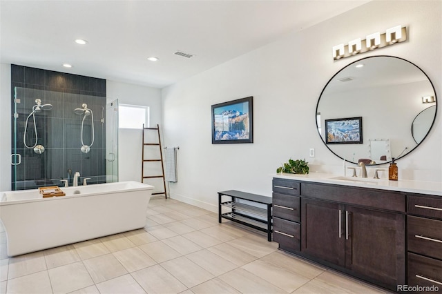 full bathroom featuring vanity, a soaking tub, recessed lighting, a tile shower, and tile patterned flooring