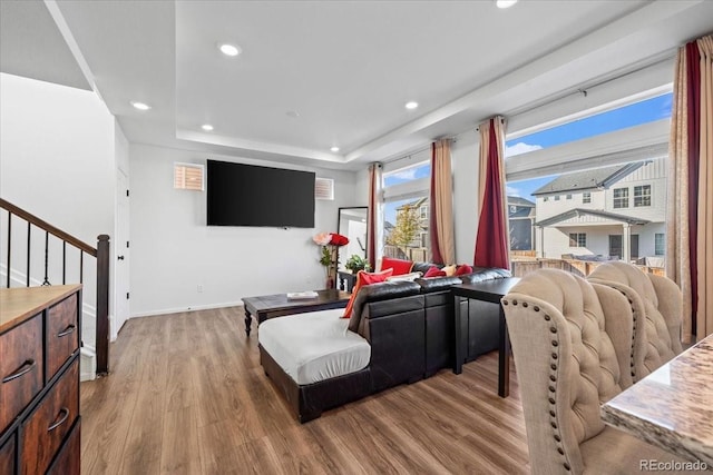 interior space with hardwood / wood-style floors and a raised ceiling