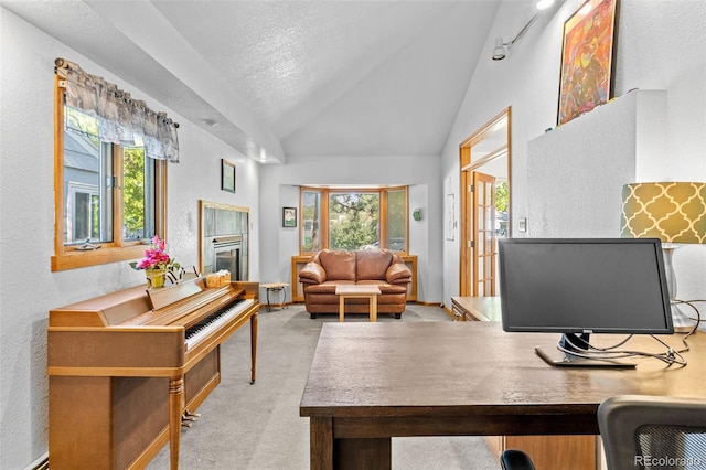 1732 Lansing St, Aurora, CO 80010 - office area featuring a textured wall, healthy amount of natural light, lofted ceiling, a tile fireplace, and light carpet
