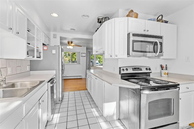 1732 Lansing St, Aurora, CO 80010 - kitchen featuring stainless steel appliances, a baseboard radiator, white cabinets, light countertops, and ceiling fan