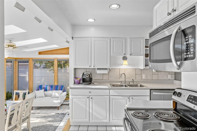 1732 Lansing St, Aurora, CO 80010 - kitchen with stainless steel microwave, range with electric cooktop, white cabinets, and recessed lighting