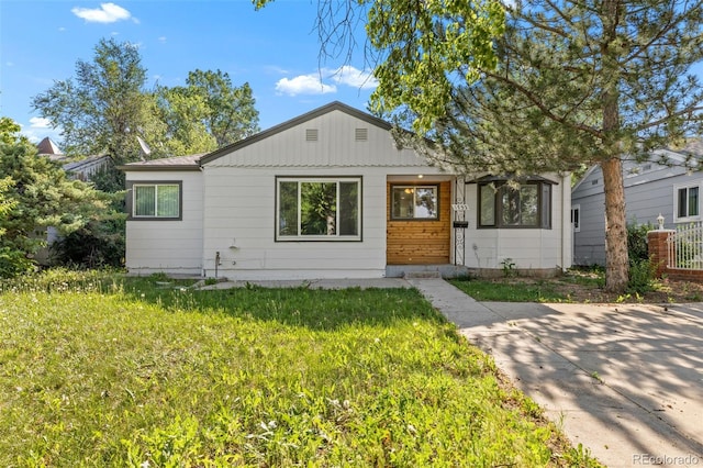 1732 Lansing St, Aurora, CO 80010 - view of front facade featuring a front yard and board and batten siding