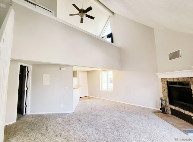 unfurnished living room featuring carpet, a ceiling fan, visible vents, a fireplace, and beamed ceiling