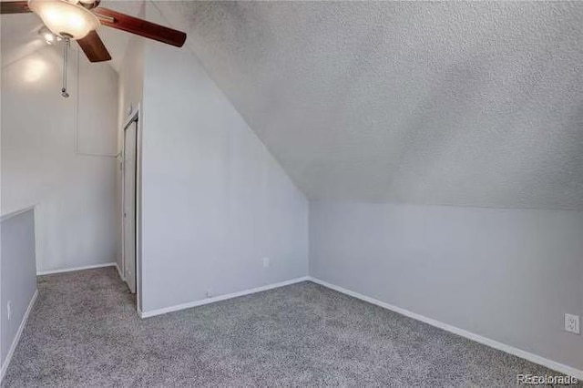 bonus room featuring a textured ceiling, ceiling fan, and carpet flooring