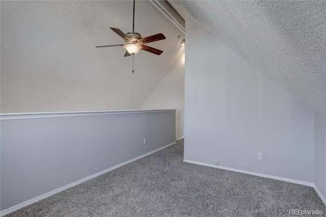 bonus room with a textured ceiling, lofted ceiling, carpet, and ceiling fan