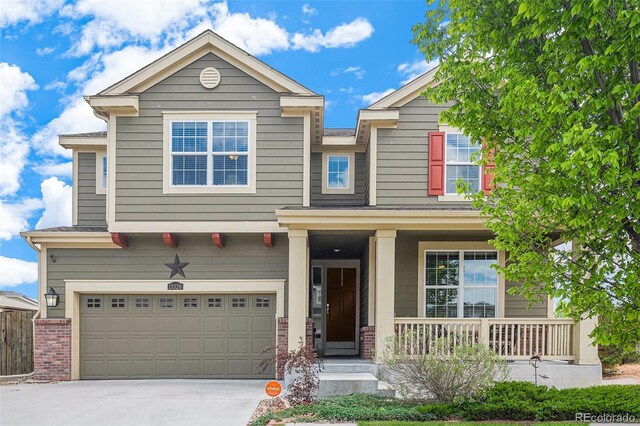 13326 Olive Way, Thornton, CO 80602 - craftsman inspired home with a porch, concrete driveway, a garage, and brick siding