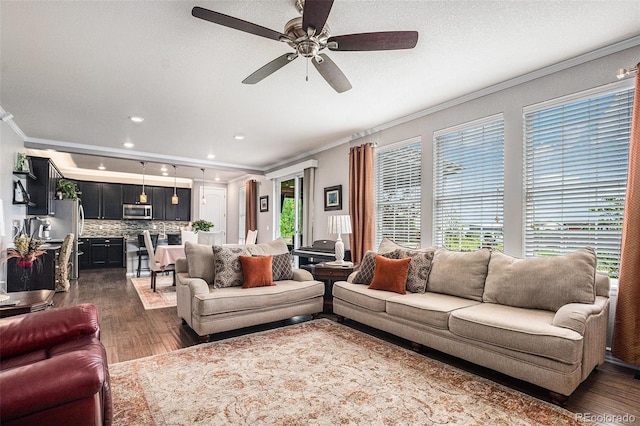 13326 Olive Way, Thornton, CO 80602 - living area featuring ornamental molding, dark wood-style floors, ceiling fan, and recessed lighting