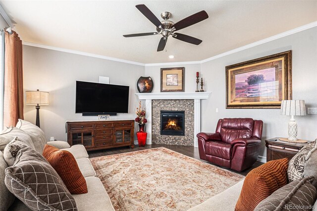 13326 Olive Way, Thornton, CO 80602 - living room with wood finished floors, ceiling fan, crown molding, a tiled fireplace, and baseboards