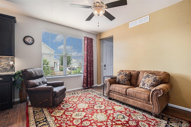 13326 Olive Way, Thornton, CO 80602 - living room featuring dark wood finished floors, ceiling fan, and baseboards