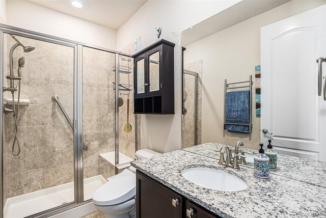 13326 Olive Way, Thornton, CO 80602 - bathroom with toilet, vanity, and a shower stall