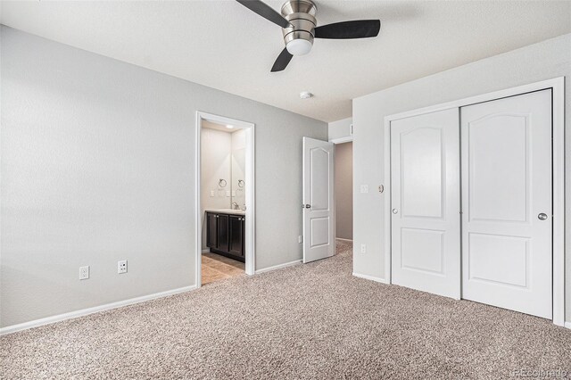 13326 Olive Way, Thornton, CO 80602 - unfurnished bedroom featuring light colored carpet, a closet, baseboards, connected bathroom, and a ceiling fan