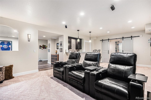13326 Olive Way, Thornton, CO 80602 - home theater with a barn door, baseboards, recessed lighting, and carpet floors
