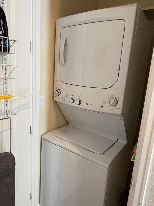 13326 Olive Way, Thornton, CO 80602 - laundry room featuring stacked washing machine and dryer