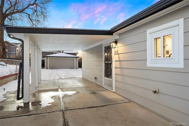 patio terrace at dusk with an outbuilding and a garage