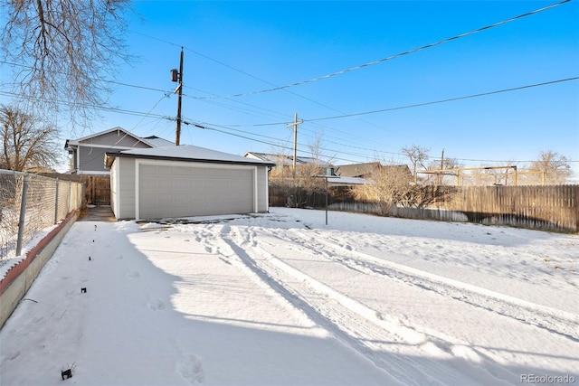 snowy yard with an outdoor structure and a garage