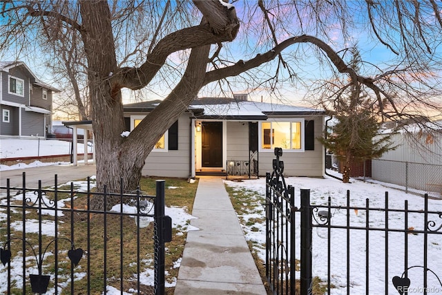 view of front of house featuring a fenced front yard and a gate