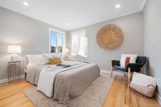 bedroom with recessed lighting, wood finished floors, and baseboards