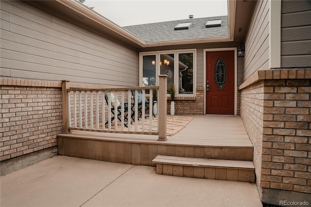 view of exterior entry featuring a deck