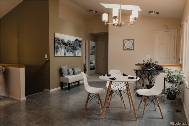 dining space with tile patterned flooring, a notable chandelier, and high vaulted ceiling